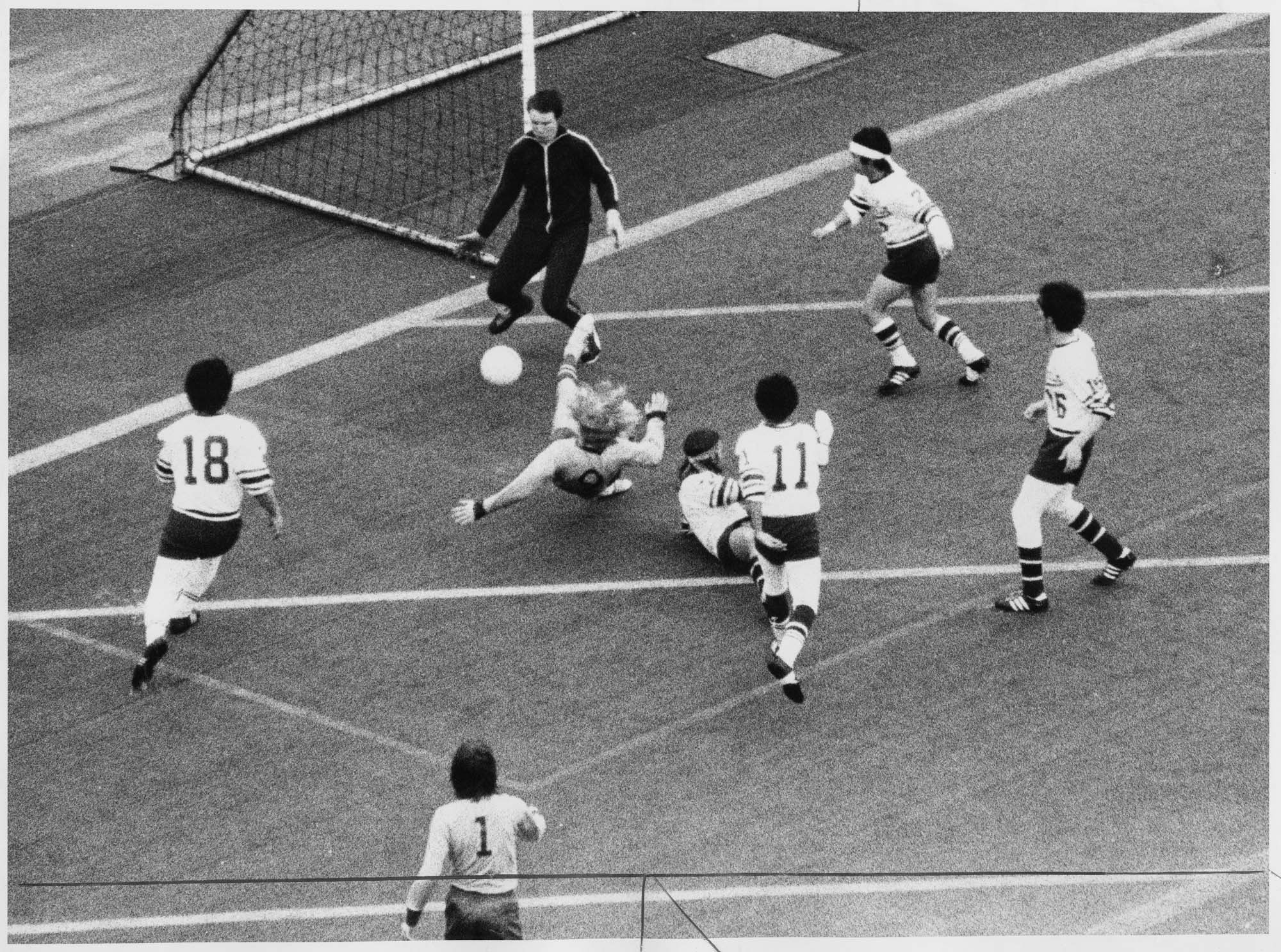 Image of West Seattle High School's Conrad Creasy slipping on artificial turf during soccer game against Franklin High, February 12, 1972