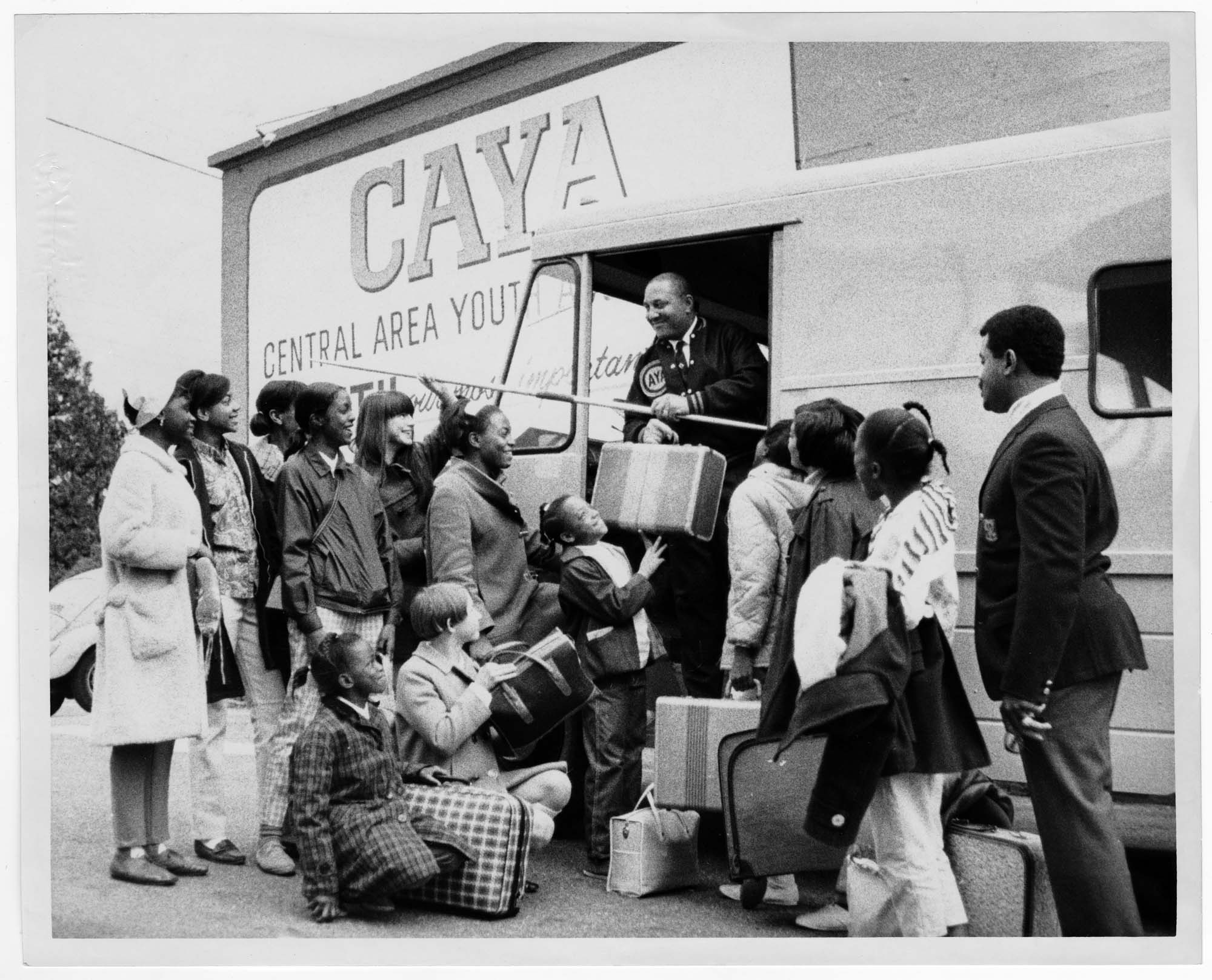 Image of Girls with luggage outside the Central Area Youth Association (CAYA) building, Seattle, April 5, 1968