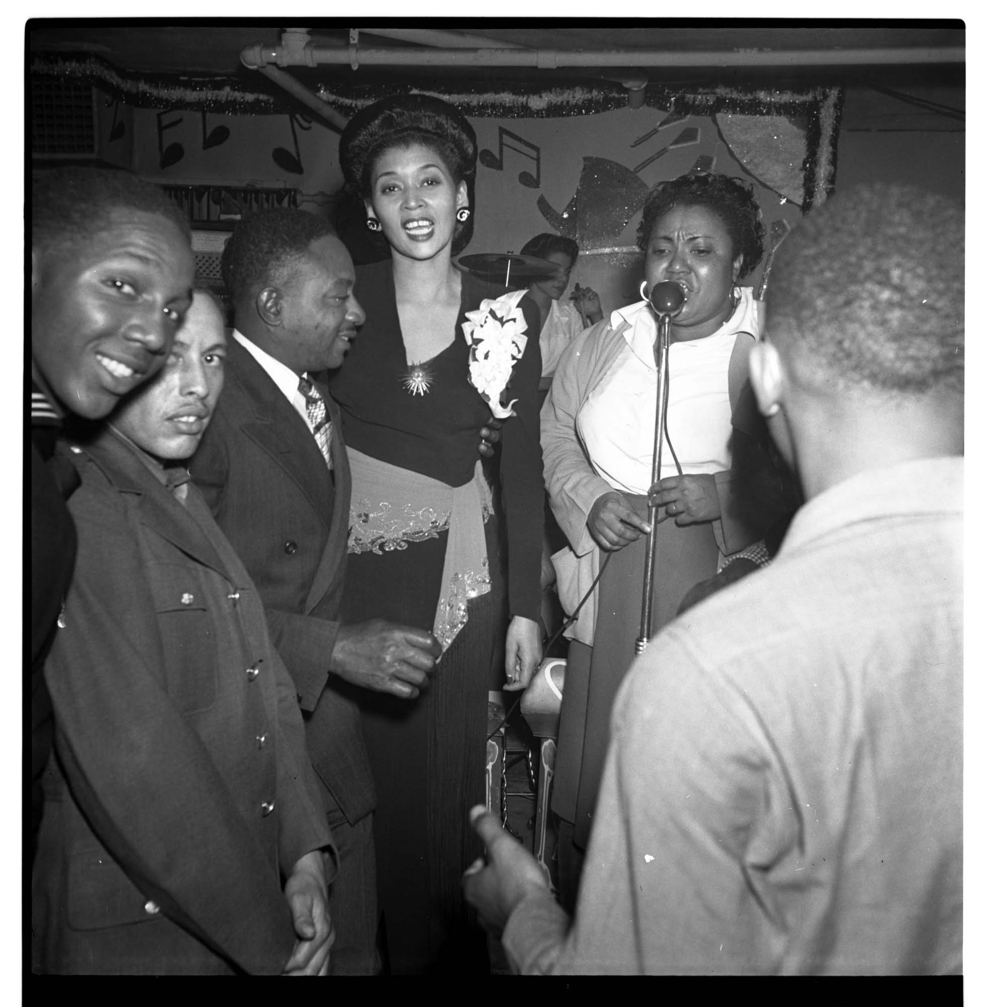 Image of Women singing at microphone at the Black & Tan nightclub, 1944