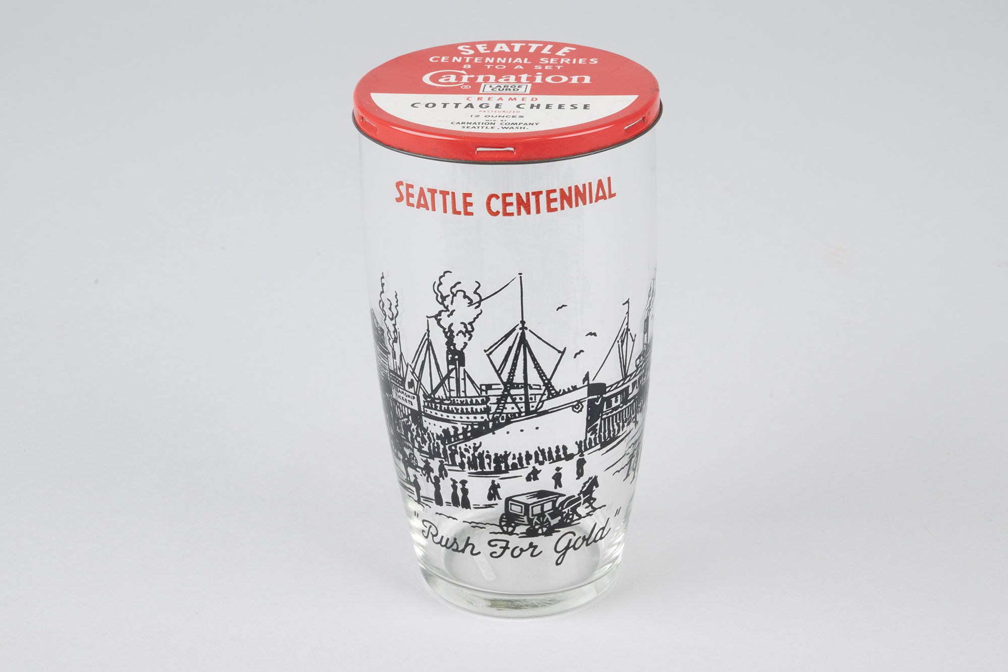 Image of Set of eight Seattle Centennial glasses with Carnation Cottage Cheese tin lids, 1952
