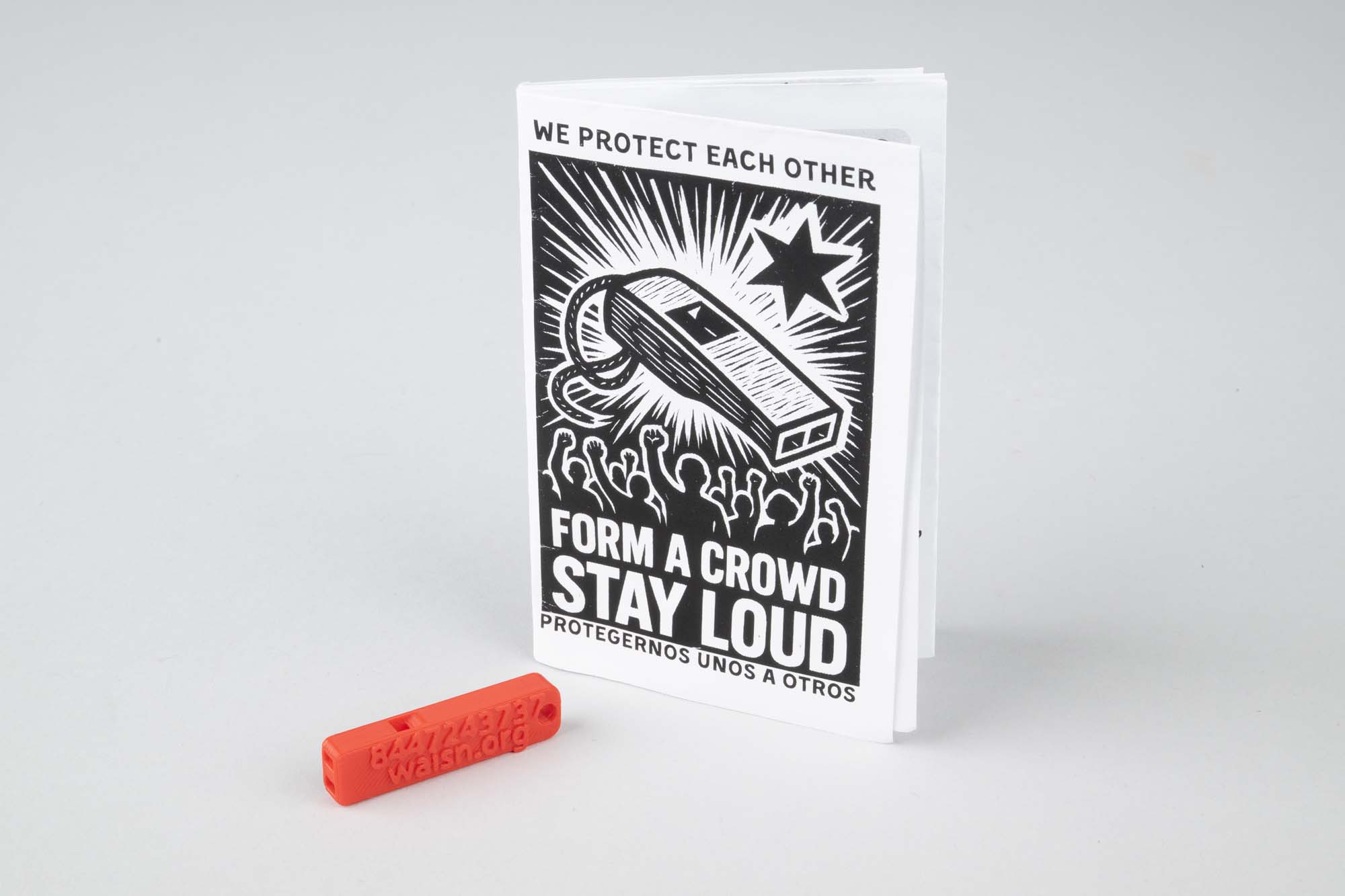 Image of Red whistle and instruction booklet for alerting neighbors to ICE activity, 2026