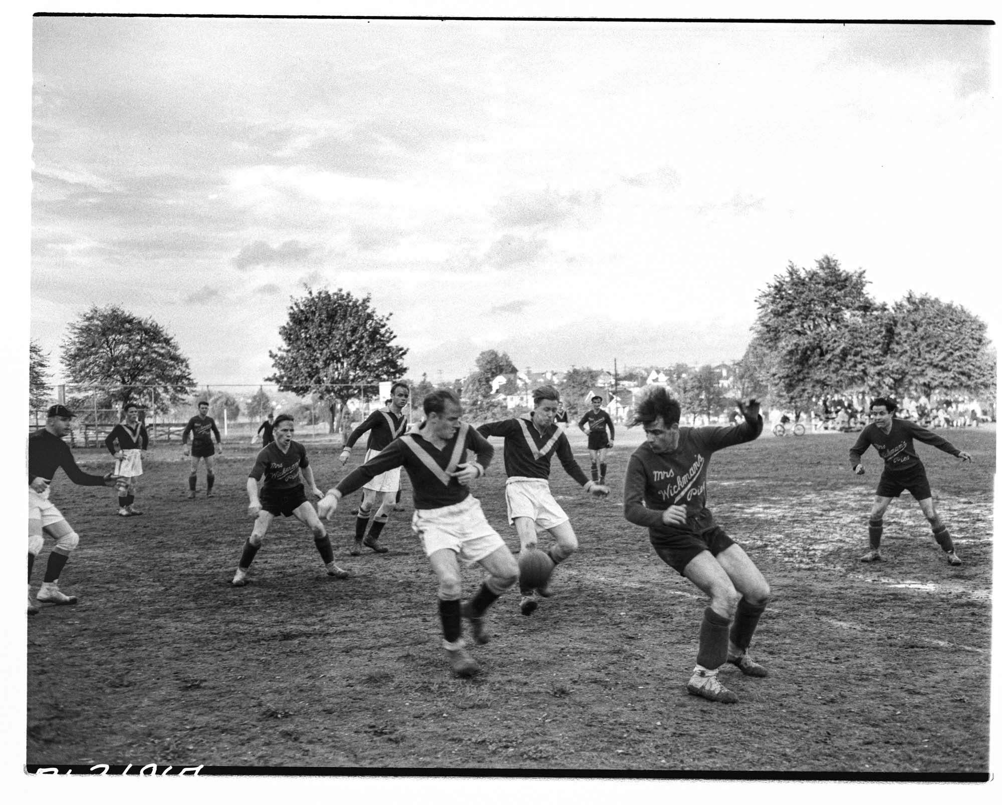 Image of Mrs. Wickman's Pie soccer team playing game with unidentified team, Seattle, October 1940