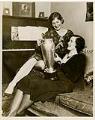 Image of Helene Madison showing another woman a swimming trophy, March 1930