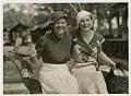 Image of Olympians Helene Madison and Georgia Coleman in street clothes sitting on wooden horse, Los Angeles, 1932