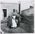 Image of Anna and Viola Brand with the family dog in backyard, Seattle, 1901