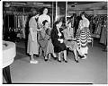 Image of Saleswoman displaying garments at Best's Apparel, Seattle, circa 1940