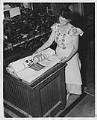 Image of Woman at Bemis Bag Co. preparing finished bags for packing, circa 1950