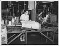 Image of Woman at Bemis Bag Co. plant with packaged paper bags, circa 1950