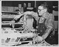 Image of Man at Bemis Bag Co. monitoring paper bag production, circa 1950
