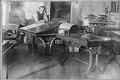 Image of Man leaning on drafting table in Bemis Bag Co. art department, Seattle, circa 1925