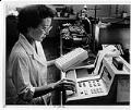 Image of Woman running AIDS computer test on vials of blood, Seattle, August 16, 1985