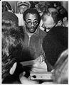 Image of UW BSU president E.J. Brisker signing University agreement after protest, May 23, 1968
