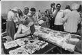 Image of Woman painting t-shirts at Pike Place Market, July 16, 1976