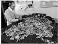 Image of Metro cashier unfolding dollar bills, Seattle, September 24, 1984