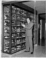 Image of Rudy Valiani inspecting wine in wine cellar at Canlis, Seattle, March 28, 1958