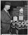 Image of George Moyer studying new transit fare boxes, Seattle, April 28, 1949