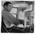 Image of Bus driver D. L. Franklin with new 10 cent fare box, Seattle, June 22, 1947