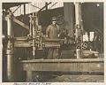 Image of Moran Brothers Company employee with drill at the shipyard on Western Avenue, Seattle, circa 1900