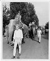 Image of J. P. Patches and Gertrude riding elephants in a parade, Seattle, circa 1975