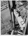 Image of Pacific Car and Foundry Co. worker tightening cable during Space Needle construction, 1961