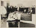 Image of Pacific Outfitting Company clothing display and customers, Seattle, circa 1930