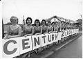 Image of Women posing with Century 21 sign during construction for the Seattle World’s Fair, 1961