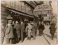 Image of Group of men looking at Currin shoe window display in Carl Schermer store, First Avenue South, Seattle, 1921
