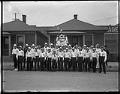Image of Members of the Amalgamated Glass Workers Local Union 63 posing with banner, Seattle, circa 1900