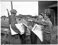 Image of U. S. Army soldier and Japanese Americans with forced removal order, Bainbridge Island, March 25, 1942