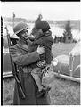 Image of U. S. soldier holding Japanese American girl during forced removal, Bainbridge Island, March 30, 1942