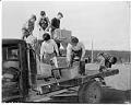 Image of Boys helping Japanese American man load truck for forced removal, Bainbridge Island, March 30, 1942