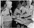 Image of HDIR member fingerprinting another, Seattle, circa 1941