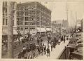 Image of Crowd watching a circus parade on Second Avenue, Seattle, circa 1900