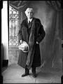 Image of Ole Hanson posing in suit and fur stole, Seattle, circa 1919