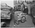 Image of L. R. Maynock collecting parking meter fees, Seattle, January 1942