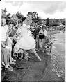 Image of Pageant queen and children on beach, Seattle, August 3, 1958