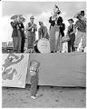 Image of Girl covering ears near band, Seattle, August 10, 1958