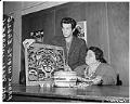 Image of Frank White Eagle and Pearl Warren examining Native American art, Seattle, January 1962