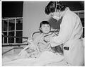 Image of Doctor examining young patient at Firland Sanatorium, Seattle, December 1, 1954