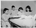 Image of Young patient giving another a gift at Firland Sanatorium, Seattle, December 1, 1954
