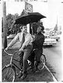 Image of TV weathermen on tandem bike, Seattle, October 13, 1971
