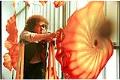 Image of Dale Chihuly adjusting glass sculpture, 1993