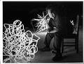 Image of Dale Chihuly sitting with neon 