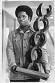 Image of Larry Gossett holding the Odegaard Award, Seattle, April 9, 1975