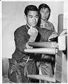 Image of Bruce Lee training with wooden Wing Chun dummy, Seattle, 1961