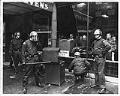 Image of Police examining broken glass outside Hotel Stevens after violent protests, Seattle, February 17, 1970