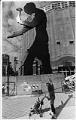 Image of Mother and child looking at Hammering Man in front of SAM, September 13, 1992