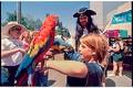 Image of Girl holding parrots at Fremont Fair, Seattle, June 20, 1993