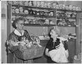 Image of Goodwill Auxiliary members displaying dolls for sale, Seattle, November 2, 1958