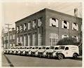 Image of New trucks parked at the Metropolitan Laundry Company, Seattle, January 8, 1938